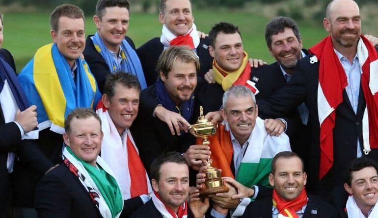 Europe team captain Paul McGinley, center right, and his team wear their national flags and celebrate with the trophy after winning the Ryder Cup golf tournament at Gleneagles, Scotland, Sunday, Sept. 28, 2014. (AP Photo/AP Photo/Peter Morrison)