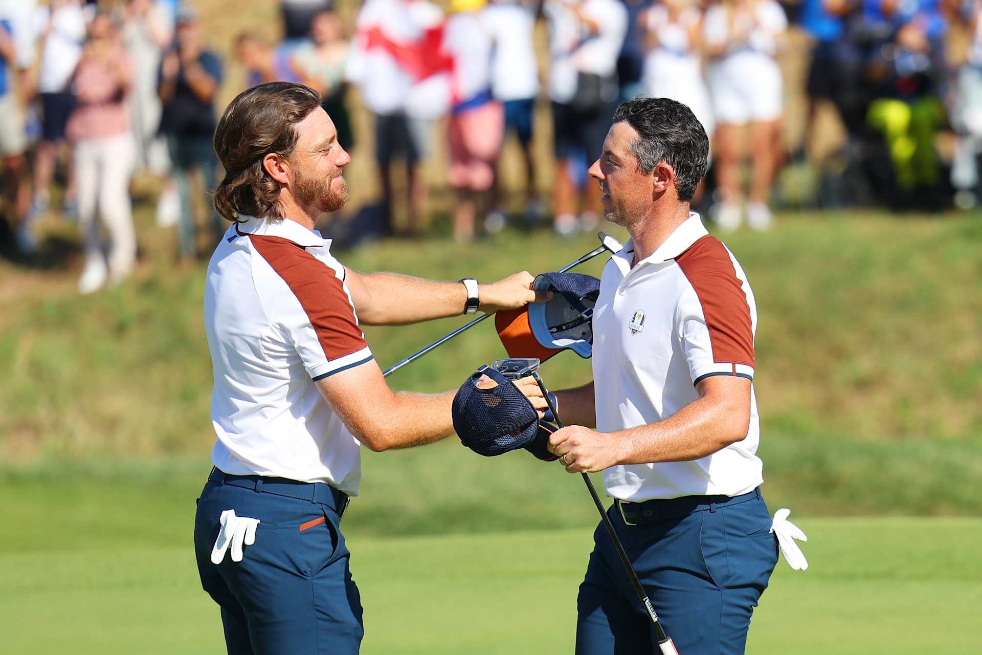 ROME, ITALY - SEPTEMBER 30: Tommy Fleetwood of Team Europe and teammate Rory McIlroy embrace on the 17th green upon winning their match 2&1 on the 17th green during the Saturday morning foursomes matches of the 2023 Ryder Cup at Marco Simone Golf Club on September 30, 2023 in Rome, Italy. (Photo by Andrew Redington/Getty Images)