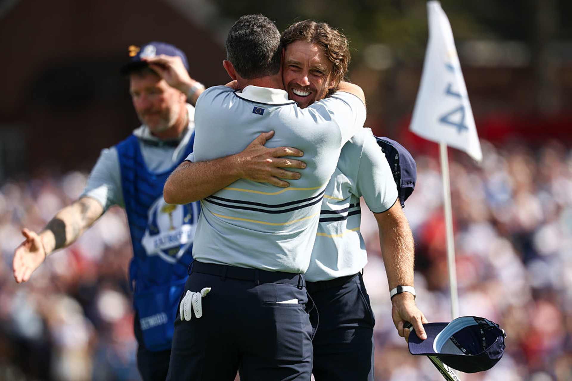 FARMINGDALE, NEW YORK - SEPTEMBER 26: Tommy Fleetwood and Rory McIlroy of Team Europe embrace after defeating Harris English and Collin Morikawa of Team United States 5&4 during the Friday morning foursomes matches of the 2025 Ryder Cup at Black Course at Bethpage State Park Golf Course on September 26, 2025 in Farmingdale, New York. (Photo by Jared C. Tilton/Getty Images)