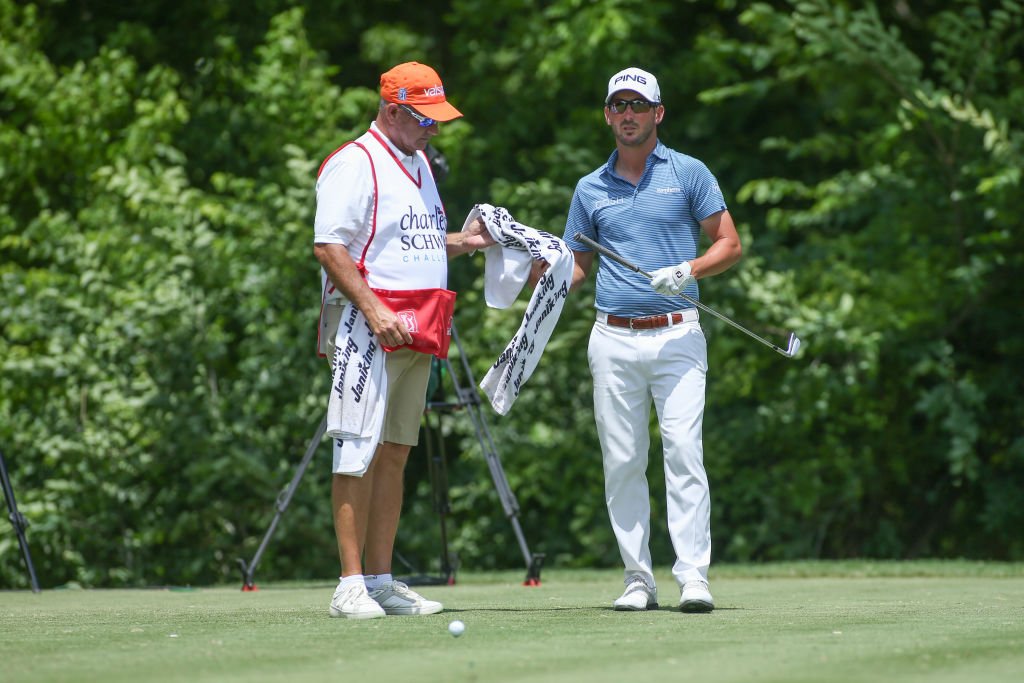 Andrew Landry takes his towel from his caddie who ensures the sponsor's name is visible.