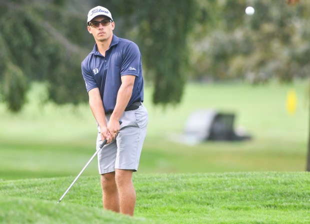 Dallas’ Ryan Roman chips on the first hole at Fox...