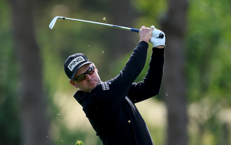 Corey Conners plays an iron shot