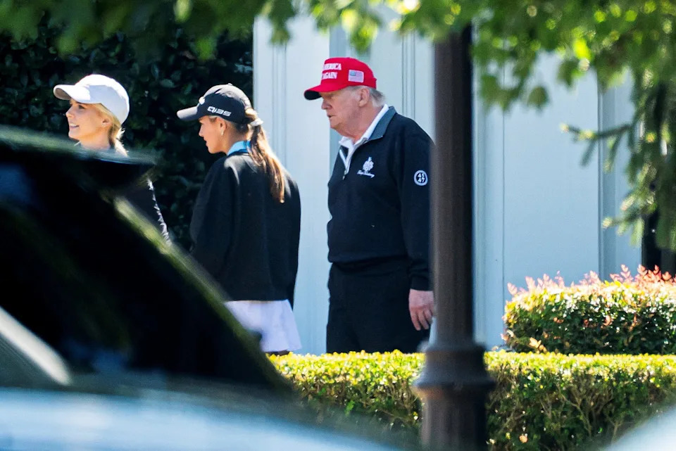 U.S. President Donald Trump departs from the Trump National Golf Club in Sterling, Virginia, U.S., August 30, 2025. He is photographed with his eldest granddaughter Kai Trump.