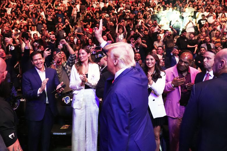 The president waves as he attends a UFC event in New Jersey in June.