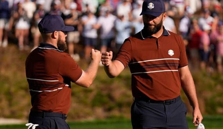 Europe's Tyrrell Hatton celebrates with Jon Rahm on the sixth hole at Bethpage Black golf course during the Ryder Cup golf tournament, Saturday, Sept. 27, 2025, in Farmingdale, N.Y. (AP Photo/Robert Bukaty)