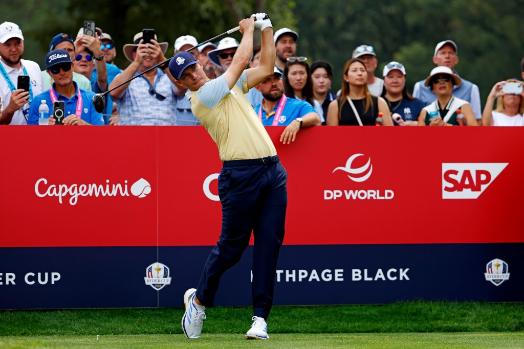Rasmus Hojgaard hitting a golf ball during a Ryder Cup practice round at Bethpage Black.