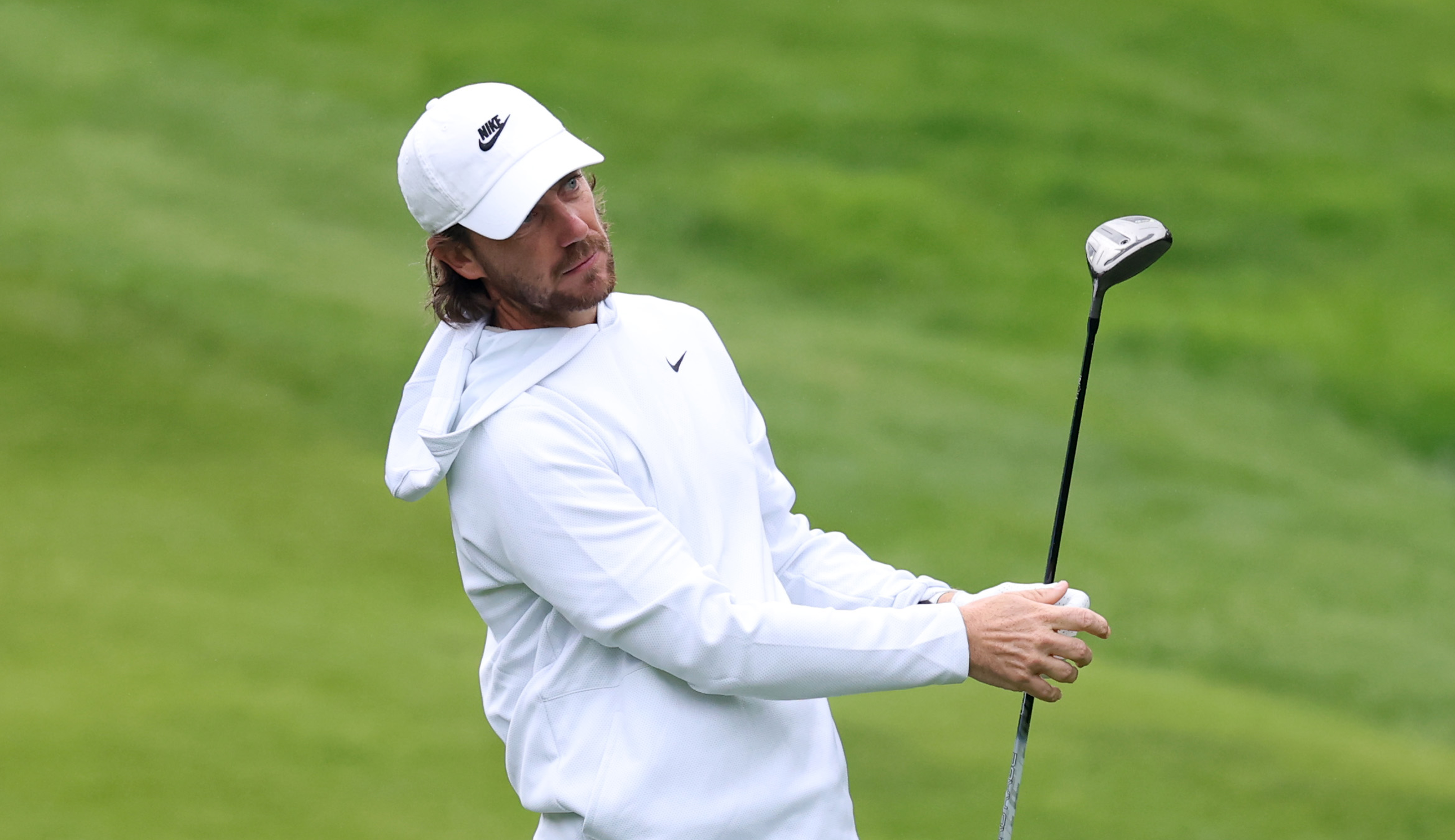 Tommy Fleetwood hits a fairway wood
