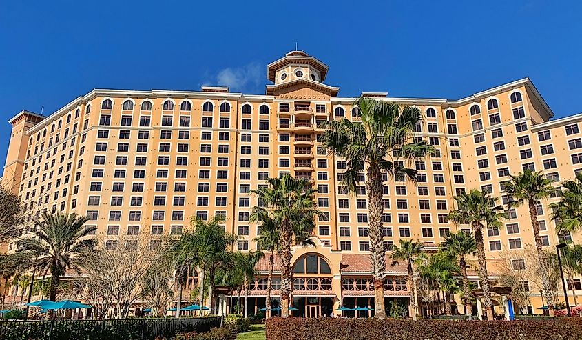  Shingle Creek Golf Club on a clear blue sky day, surrounded by palm trees. 