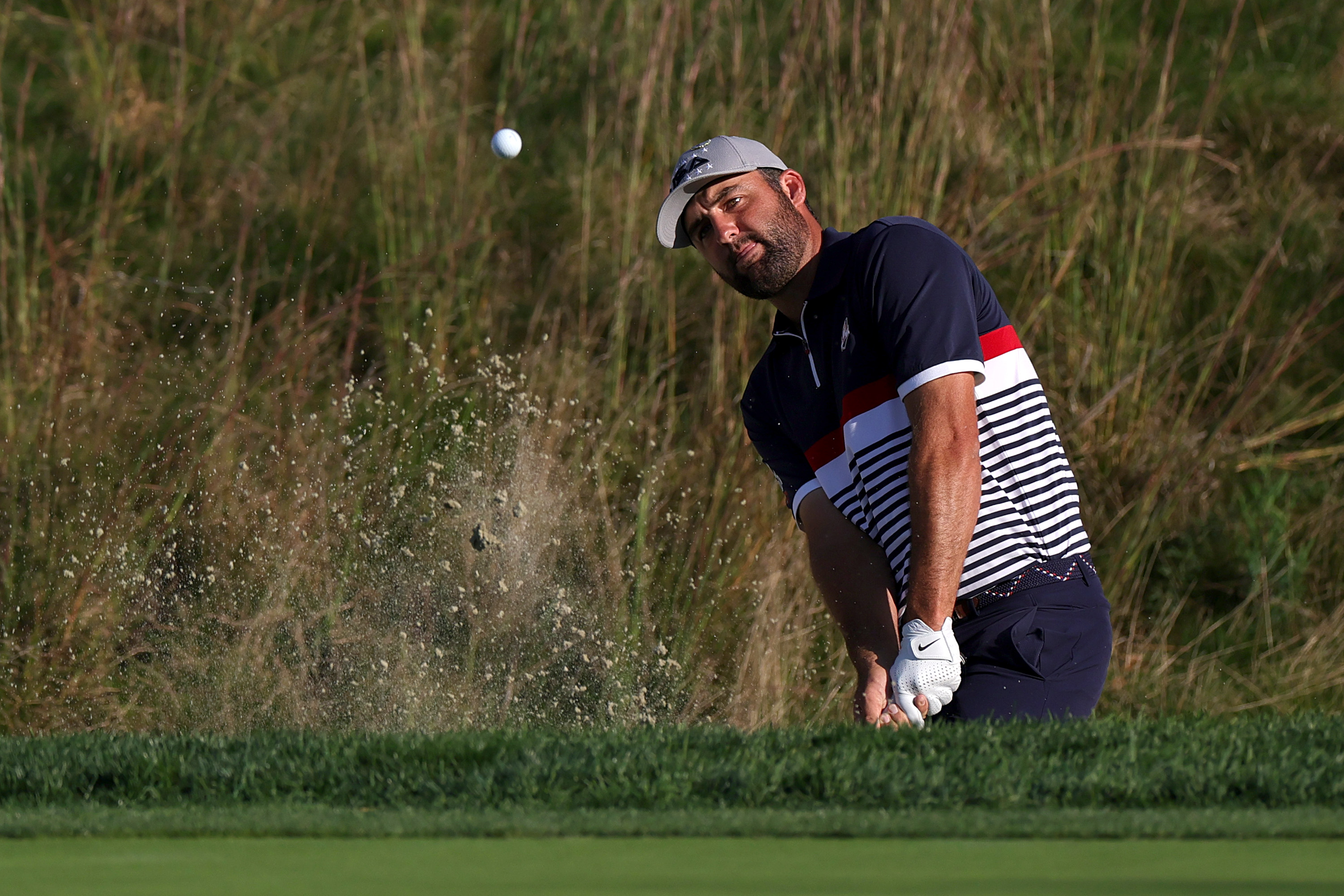 Scottie Scheffler hits a bunker shot