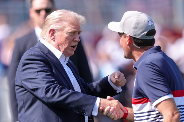 FARMINGDALE, NEW YORK - SEPTEMBER 26: U.S. President Donald Trump shakes hands with Keegan Bradley, Captain of Team United States on the first tee during the Friday afternoon four-ball matches of the 2025 Ryder Cup at Black Course at Bethpage State Park Golf Course on September 26, 2025 in Farmingdale, New York. (Photo by Andrew Redington/Getty Images) *** BESTPIX ***