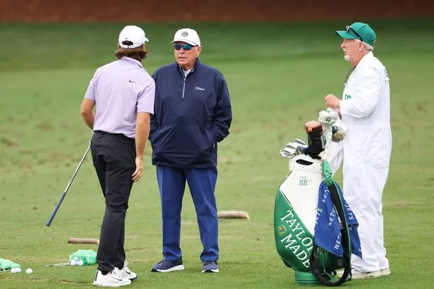  Tommy Fleetwood of England speaks with coach Butch Harmon
