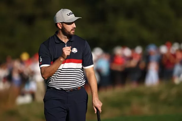 Patrick Cantlay of Team United States reacts after winning the 12th