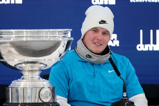 Bob MacIntyre speaks at a press conference beside the Alfred Dunhill Links Championship trophy