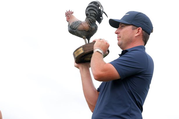 Steven Fisk holds the Sanderson Farms Championship trophy