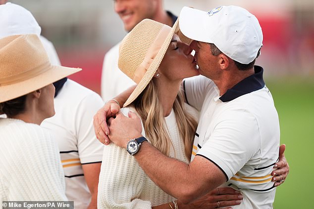 There was no mistaking the pride in her gaze as she reached out for a kiss and a warm embrace as her husband walked towards her after his team clinched victory on Sunday afternoon
