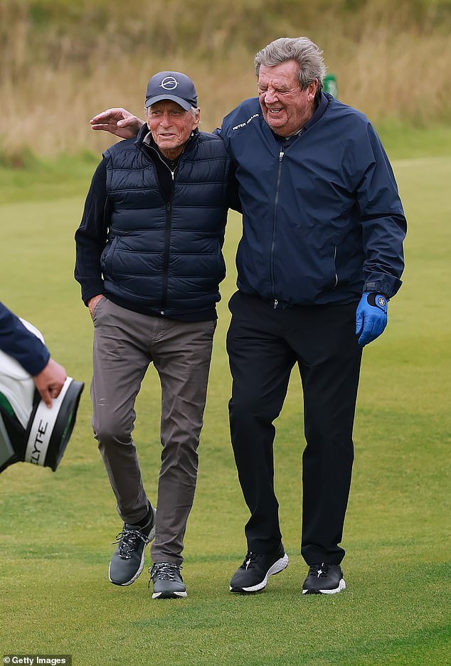 Earlier in the day her husband Michael, 81, was seen sporting a navy cap, a blue body warmer and grey trousers as he enjoyed a game alongside Richemont chairman Johann Rupert