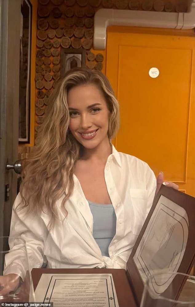 She was all smiles as she sat for dinner in Europe and opened the menu in front of her