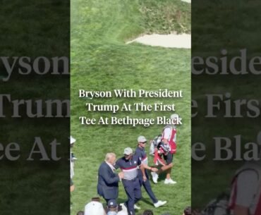 President Trump walks onto the first tee alongside Bryson DeChambeau.