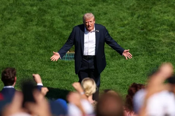 FARMINGDALE, NY - SEPTEMBER 26: President of the United States Donald Trump greets spectators by the first hole tee box during the 2025 Ryder Cup on the Black Course at Bethpage State Park on Friday, September 26, 2025 in Farmingdale, New York. (Photo by Scott Taetsch/PGA of America via Getty Images)