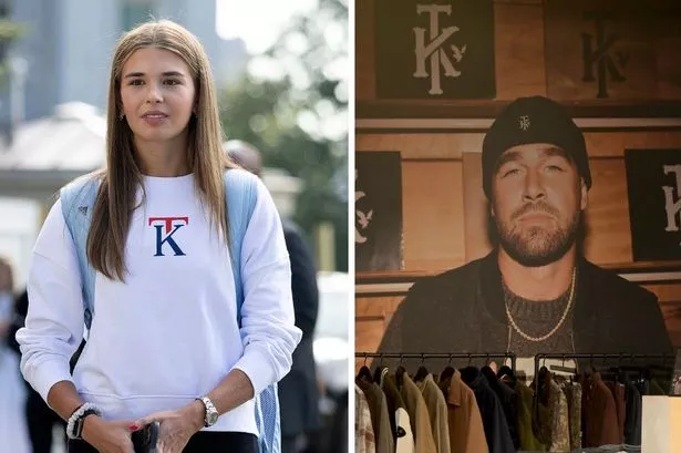 Kai Trump and Travis Kelce wear their initial logo merch