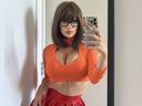 Paige Spirinac wears a Halloween costume inspired by the character Velma from Scooby Doo.