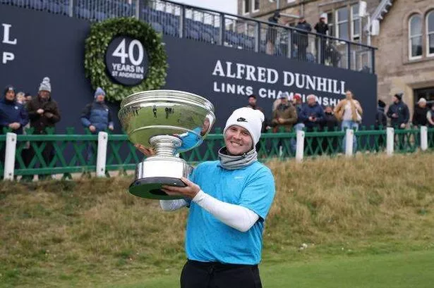 ST ANDREWS, SCOTLAND - OCTOBER 05: Robert MacIntyre of Scotland poses with the trophy on the 18th green following victory in the