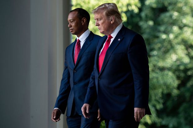 US President Donald Trump and professional golfer Tiger Woods walk to a Presidential Medal of Freedom ceremony in the Rose Garden of the White House on May 6, 2019, in Washington, DC