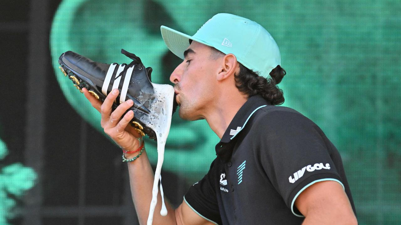 Chile's Joaquin Niemann drinks from his shoe while celebrating victory during the final day of the LIV Golf Adelaide at the Grange Golf Club in Adelaide on February 16, 2025. (Photo by Brenton Edwards / AFP) / -- IMAGE RESTRICTED TO EDITORIAL USE - STRICTLY NO COMMERCIAL USE --