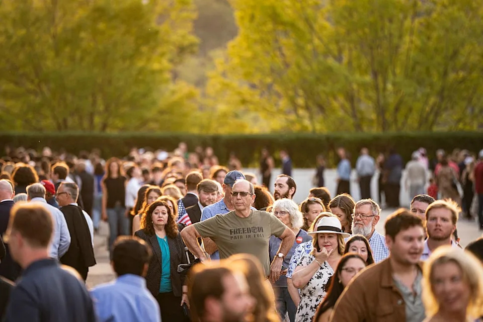 People wait in line prior to a prayer vigil for political activist Charlie Kirk outside the John F. Kennedy Center for the Performing Arts on September 14, 2025 in Washington, DC.  / Al Drago / Getty Images