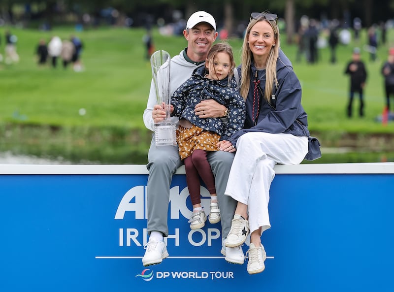 Rory McIlroy celebrates winning the Amgen Irish Open with his wife Erica Stoll and daughter Poppy. Photograph: Bryan Keane/Inpho
