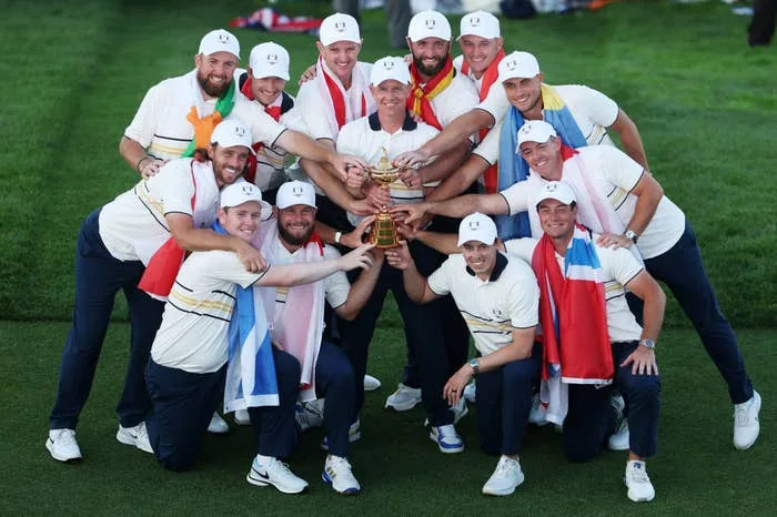 Team celebrating victory on a golf course, holding up a trophy together, wearing matching golf attire and various country-themed scarves