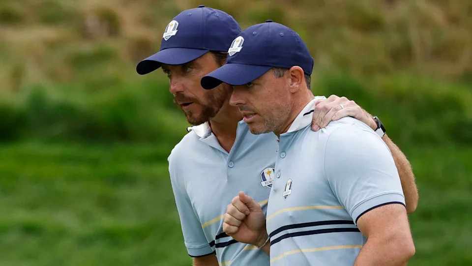 Tommy Fleetwood and Rory McIlroy of Team Europe celebrate after making a putt on the eighth green during the Friday morning foursomes matches of the 2025 Ryder Cup