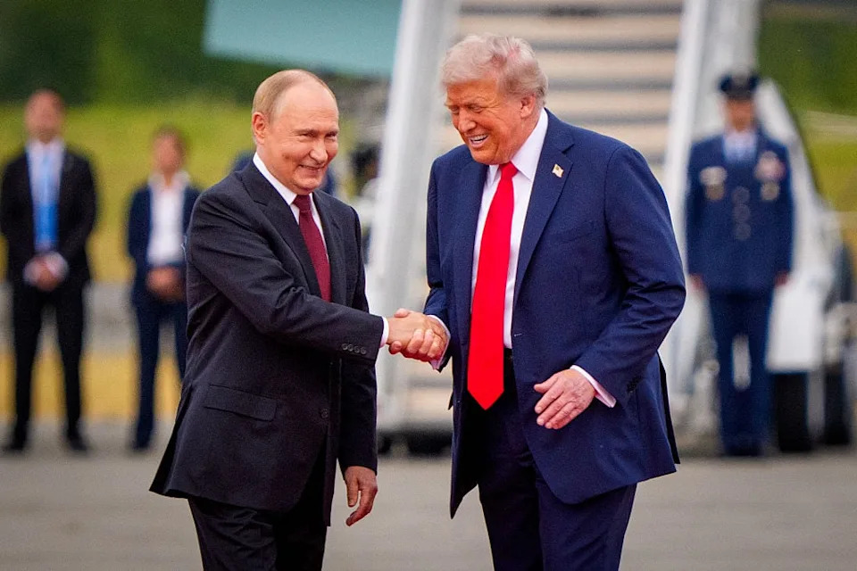 U.S. President Donald Trump (R) greets Russian President Vladimir Putin as he arrives at Joint Base Elmendorf-Richardson on August 15, 2025 in Anchorage, Alaska. The two leaders are meeting for peace talks aimed at ending the war in Ukraine. / Andrew Harnik / Getty Images