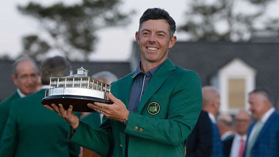 Rory McIlroy holding the Masters trophy in the famous green jacket