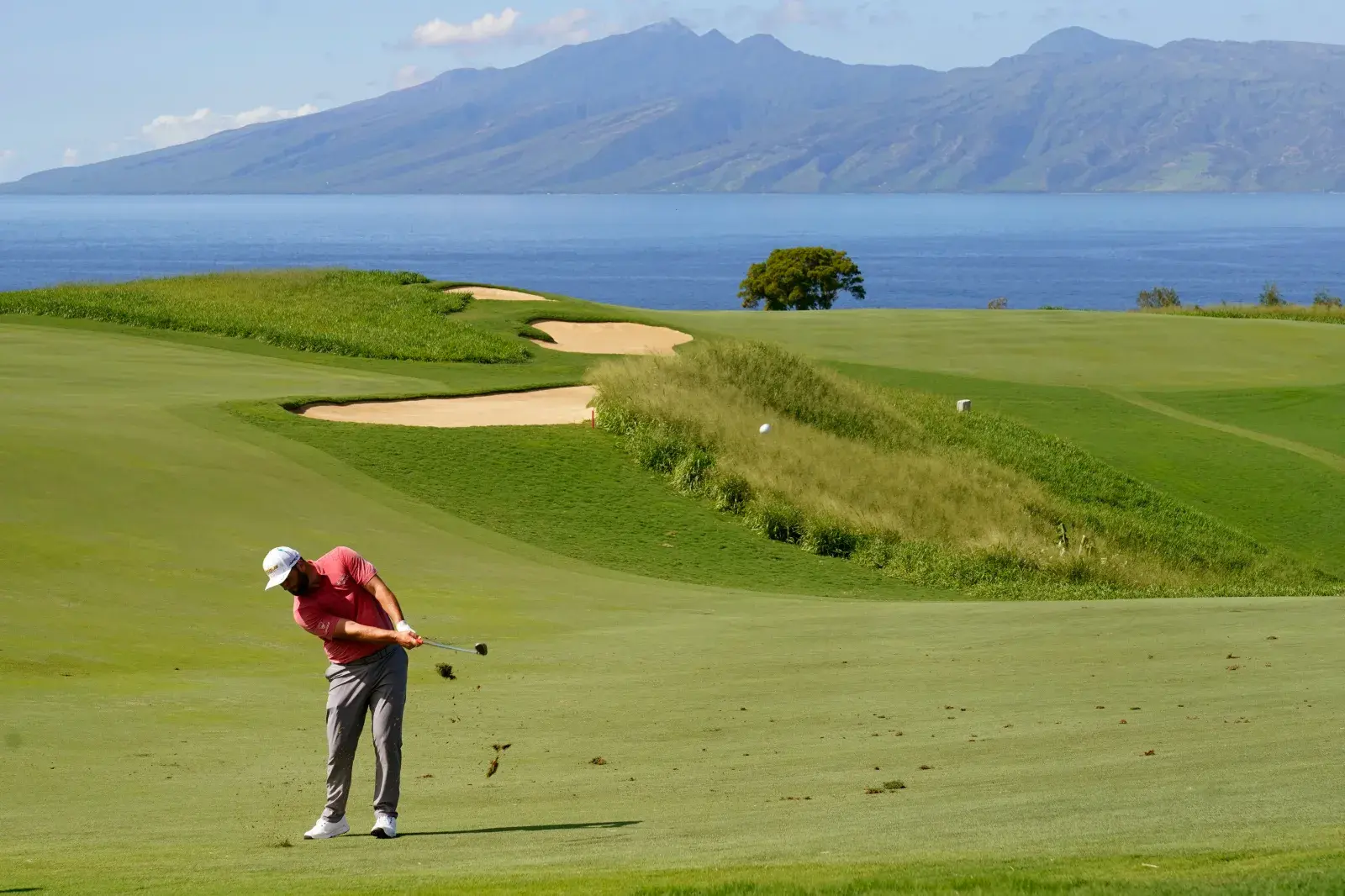 Jon Rahm, of Spain, hits from the 13th fairway during the final round of the Tournament of Champions golf event, in 2022, at Kapalua Plantation Course in Kapalua, Hawaii.
