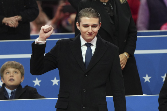 Barron Trump gestures as he arrives at an indoor Presidential Inauguration parade event in Washington, Monday, Jan. 20, 2025. (AP Photo/Matt Rourke)