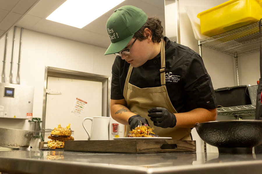 Jace Burroughs, the executive chef of the Bellhouse in Idaho Falls Country Club preparing dishes in the kitchen. | Daniel V. Ramirez, EastIdahoNews.com