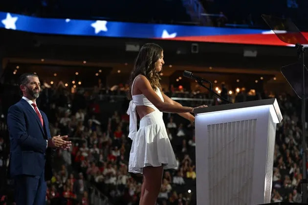 Donald Trump Jr., left, looks on as his daughter Kai Madison Trump speaks during the third day of the 2024 Republican National Convention in Wisconsin.