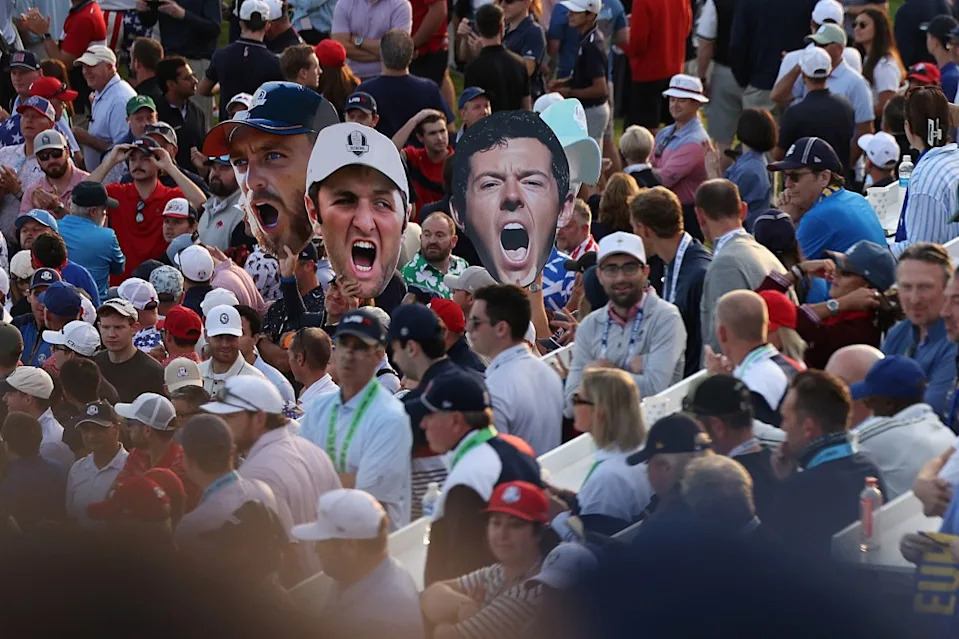 Spectators hold giant signs displaying the faces of Tommy Fleetwood (L), Jon Rahm and Rory McIlroy of Team Europe during the foursomes matches at the Ryder Cup on September 27, 2025 in Farmingdale, New York. Getty Images