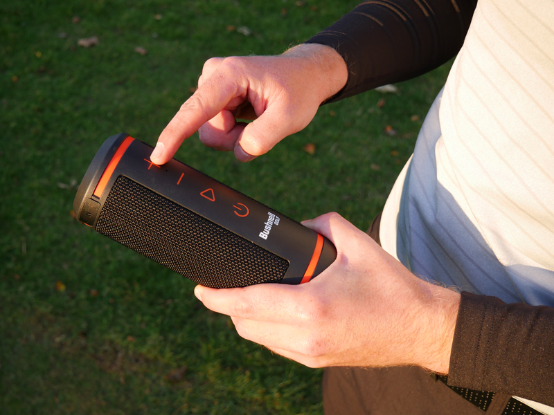 The Bushnell Wingman speaker in a golfer's hands
