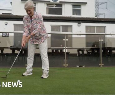 Female golfer on a putting green