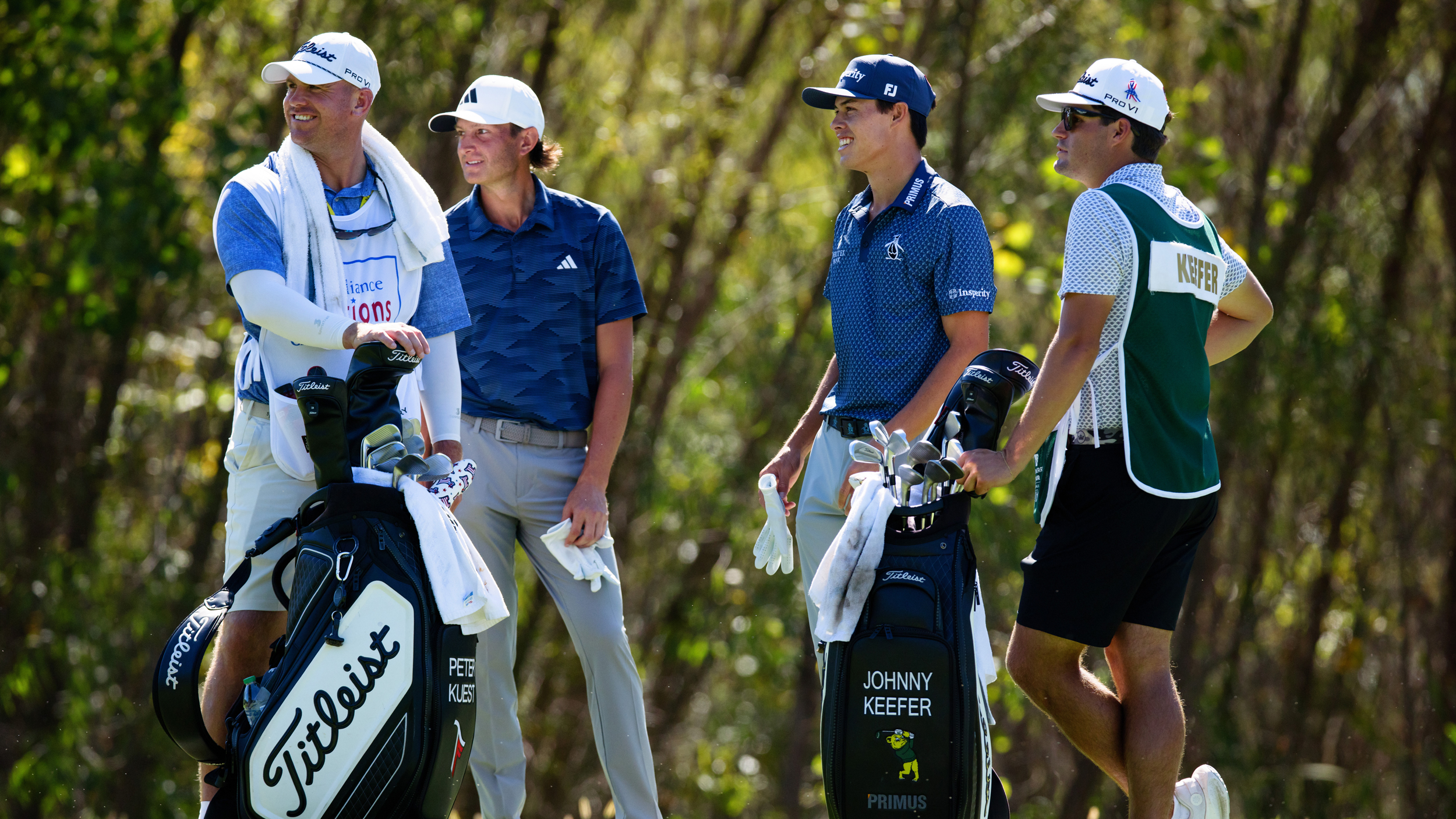 Peter Kuest (second left) and Johnny Keefer (second right) stand next to their caddies during the final round of the 2025 Compliance Solutions Championship
