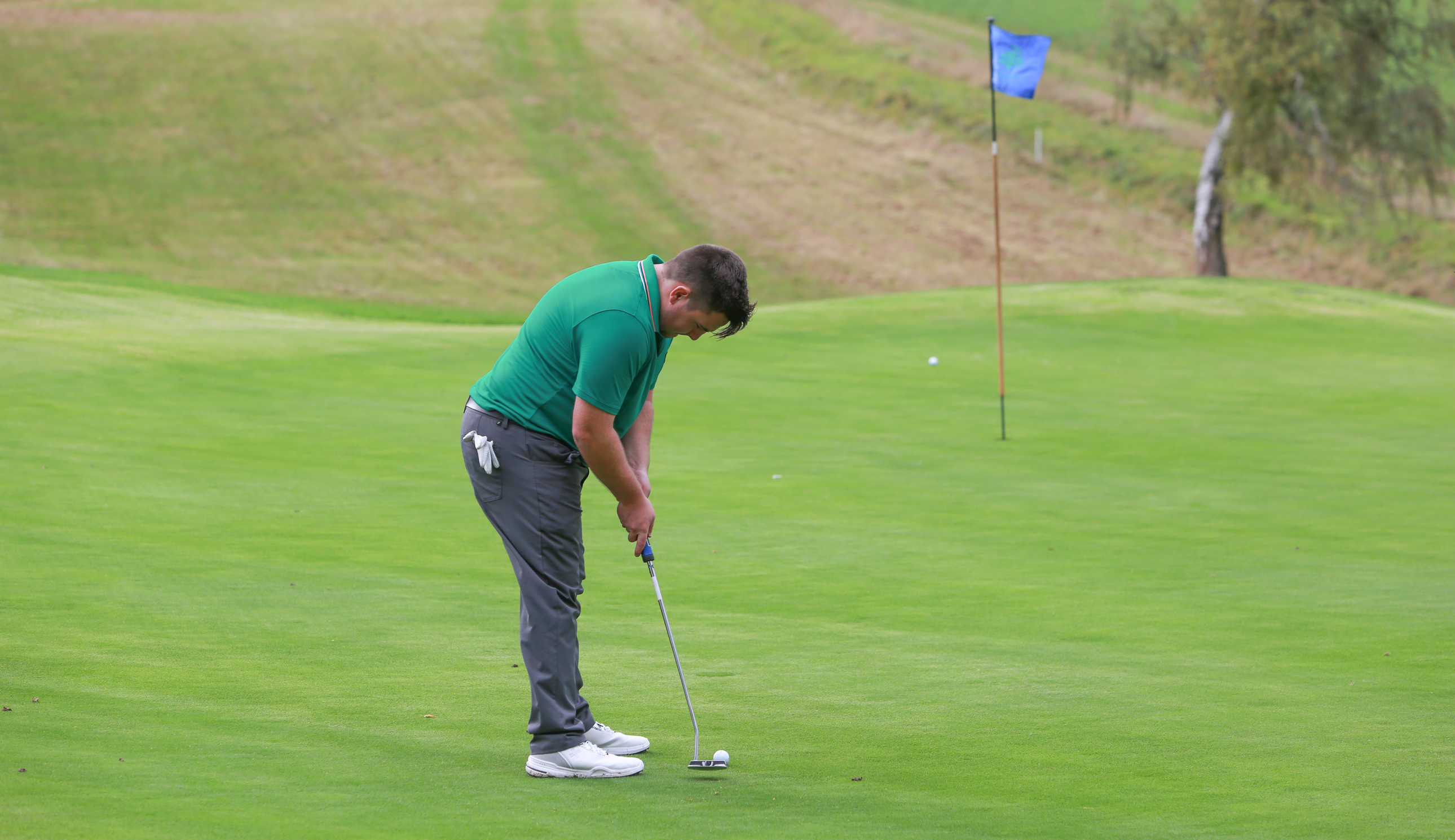 A golfer hits a lengthy putt