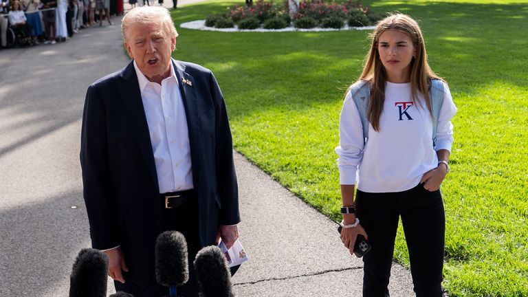 Kai Trump watches as her grandfather President Donald Trump speaks to reporters before departing the White House, Friday, Sept. 26, 2025, in Washington. (AP Photo/Julia Demaree Nikhinson)