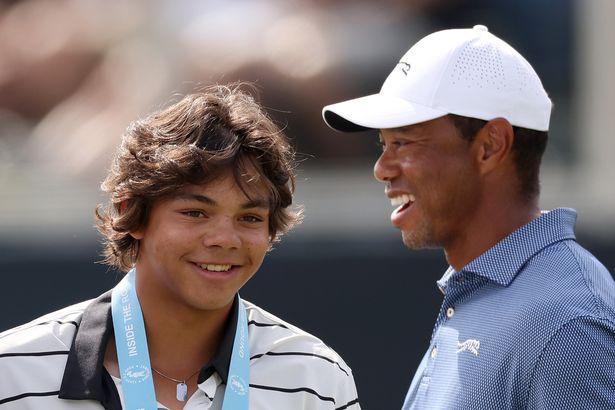 Tiger Woods and son Charlie Woods look on from the 18th green during a practice round prior to the U.S. Open at Pinehurst