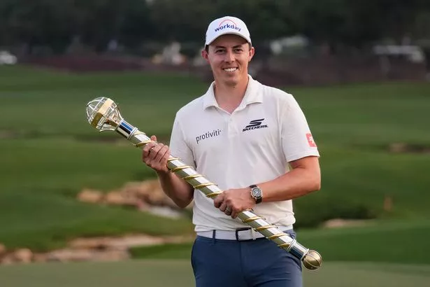 Matt Fitzpatrick of England poses with World Tour Golf Championship trophy