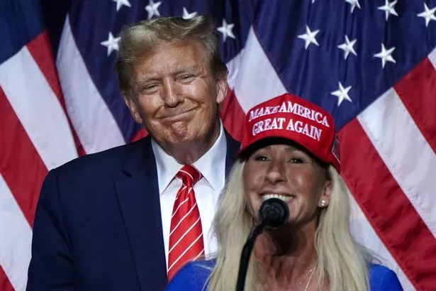 US Representative Marjorie Taylor Greene (R) speaks alongside former US President and 2024 presidential hopeful Donald Trump at a campaign event in Rome, Georgia, on March 9, 2024. 
