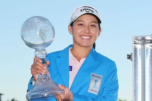 Jeeno Thitikul of Thailand poses with the trophy after winning the CME Group Tour Championship trophy