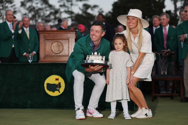 Rory McIlroy poses with his wife, Erica, and daughter, Poppy, after winning the Masters