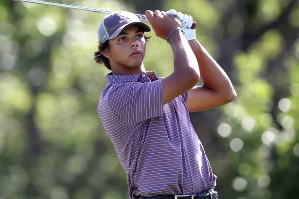 Charlie Woods swings a golf club